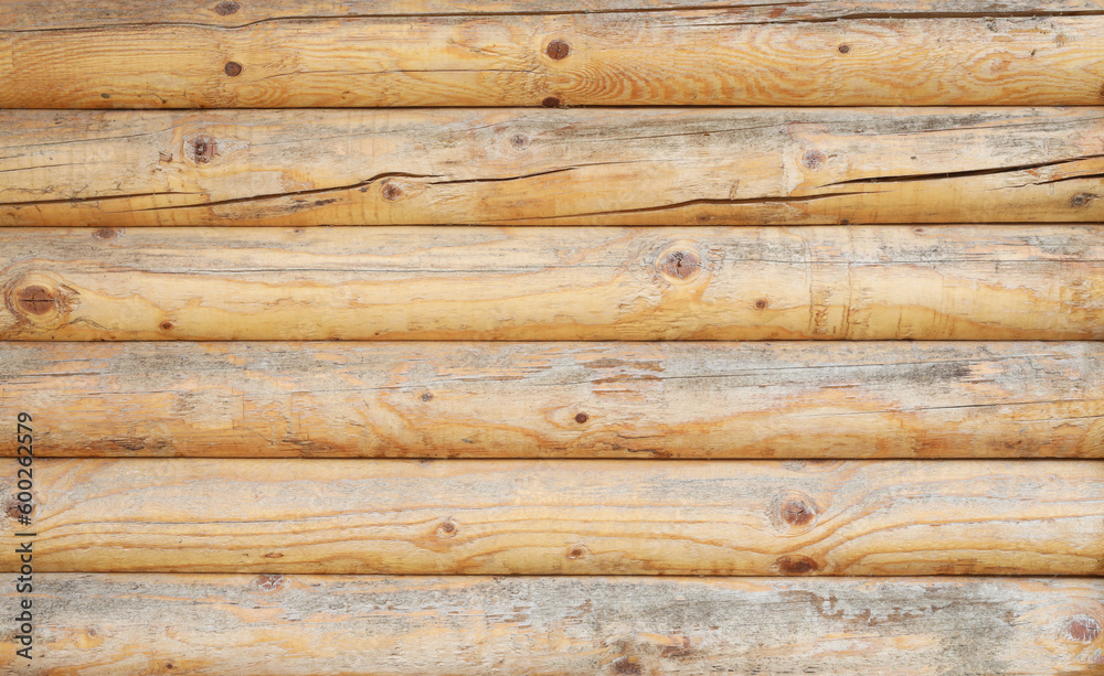Wooden wall assembled of beams or logs. Natural building concept. Brown background nature idea