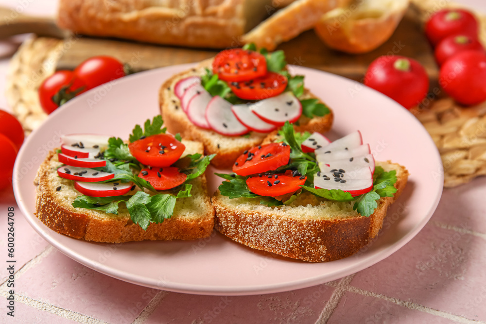 Plate with delicious radish bruschettas on pink tiled table