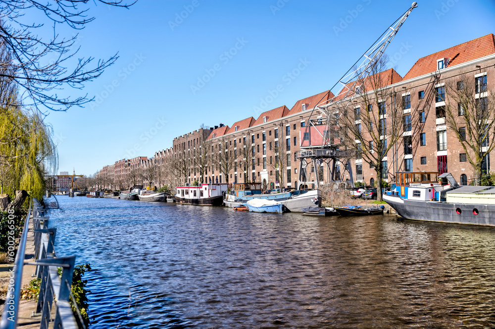 Amsterdam, Netherlands - March 28, 2023: Iconic houses along the streets and canals of Amsterdam
