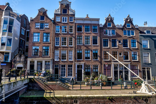 Amsterdam, Netherlands - March 28, 2023: Iconic houses along the streets and canals of Amsterdam
