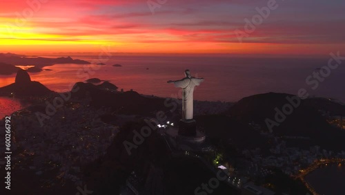 RIO DE JANEIRO, BRASIL - MAY, 2023: Drone aerial view of of a famous landmark Christ the Redeemer statue on Corcovado mauntain at sunrise. most visited tourist site in Rio at sunny day from above.