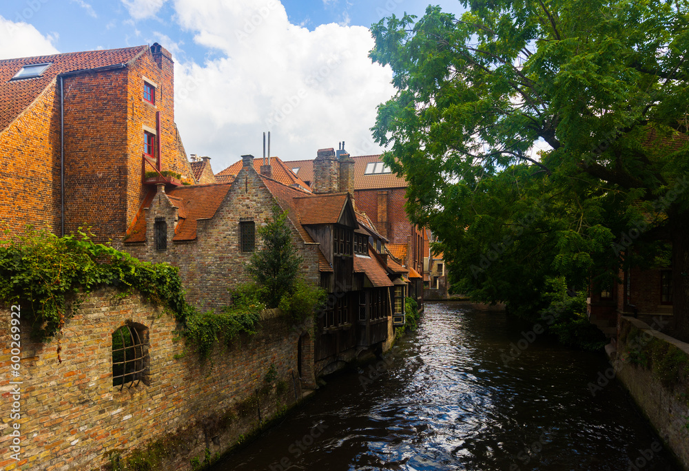 Stone buildings along canal in Bruges, Belgium. Capital of province of West Flanders.