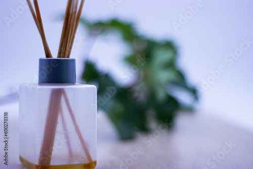 air freshener perfume diffuser with green and white background