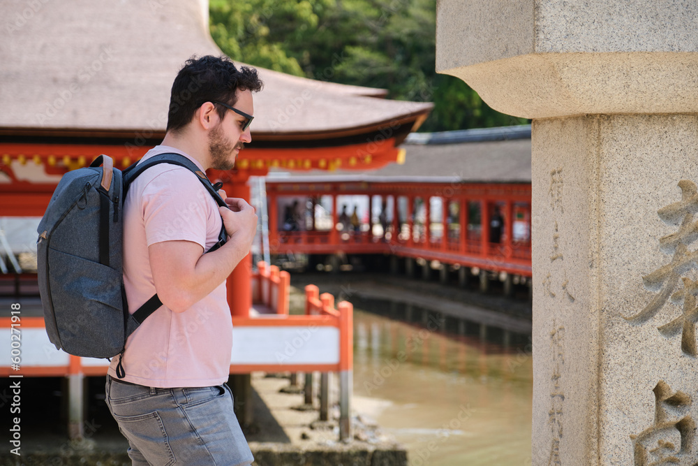 European tourist visiting Itsukushima Jinja in Miyajima, Hiroshima, Japan. European tourist visiting Itsukushima Jinja in Miyajima, Hiroshima, Japan.