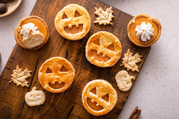 Mini pumpkin pies with jack o lanterns decoration