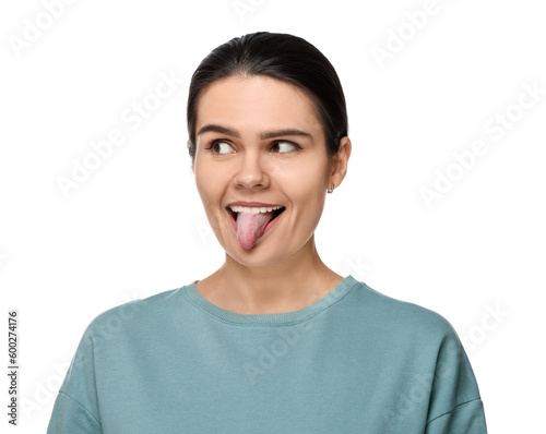 Happy young woman showing her tongue on white background