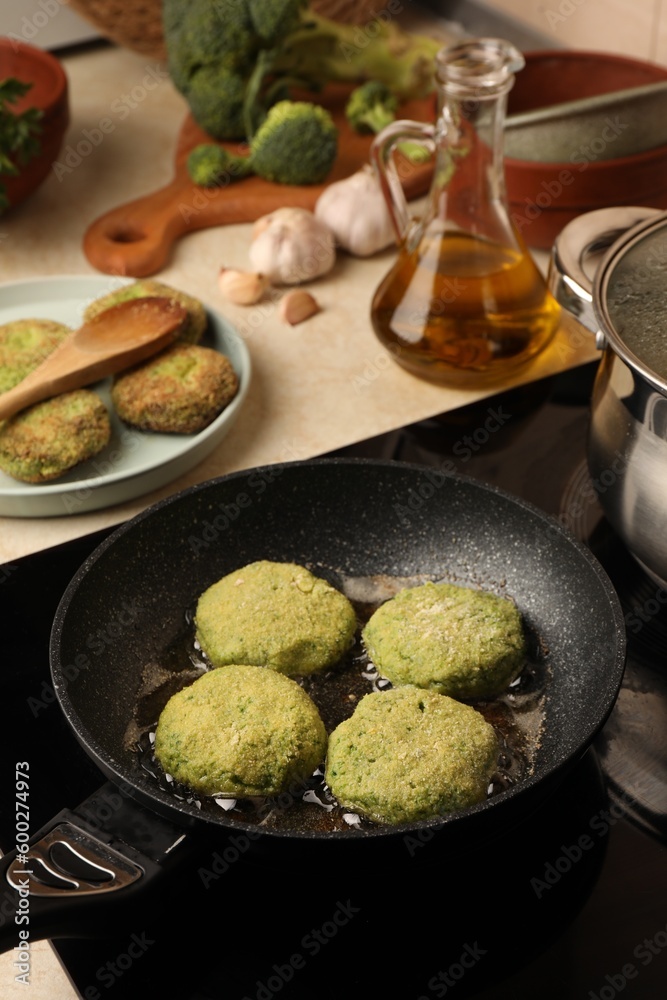Cooking vegan cutlets in frying pan on stove Cooking vegan cutlets in frying pan on stove