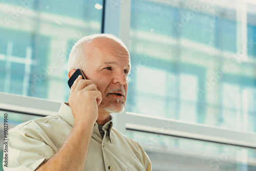 old man phones with a mobile phone photo