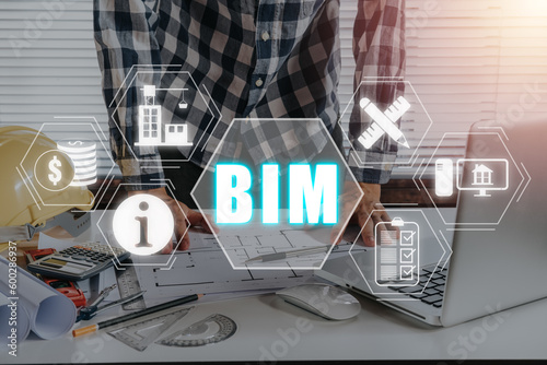 BIM  Building Information Modeling Technology concept  Engineering man working on desk with Building Information Modeling icon on virtual screen.