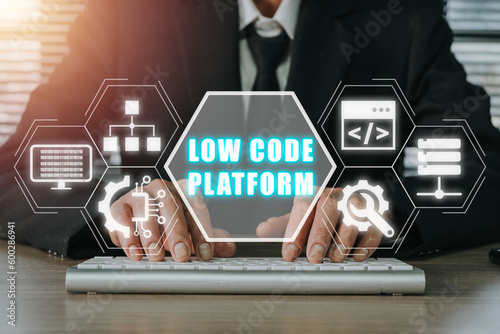 Low Code software development platform technology concept, Businessman typing on keyboard computer with low code platform icon on virtual screen.