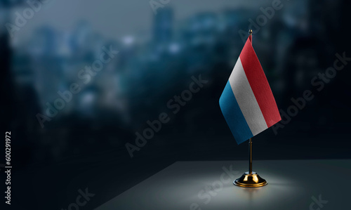 Foto A small Luxembourg flag on an abstract blurry background