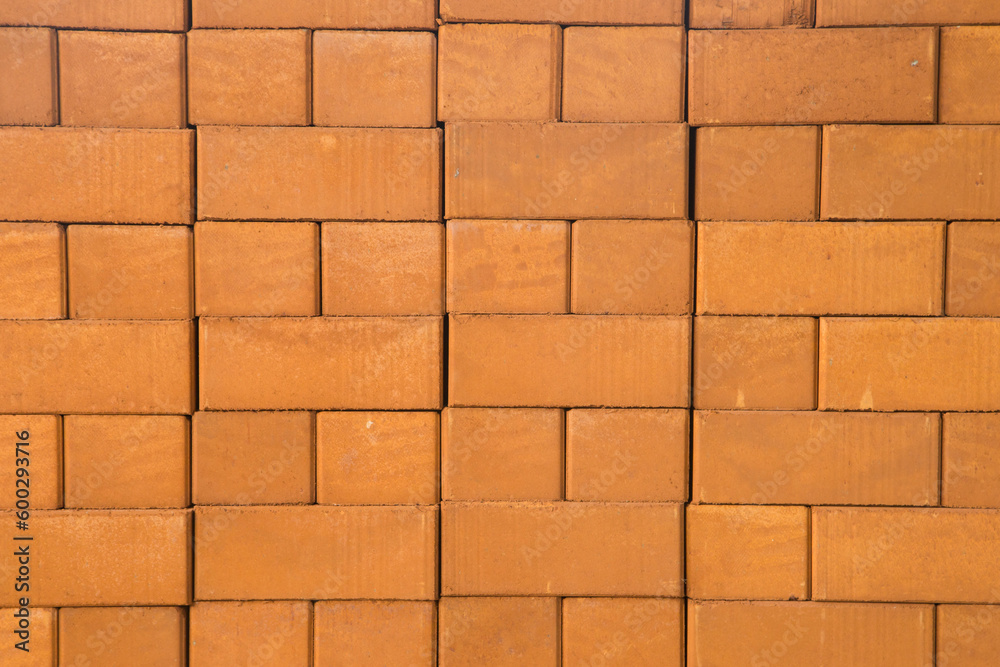 Obraz premium Reddish-brown bricks stacked together, textured background.
