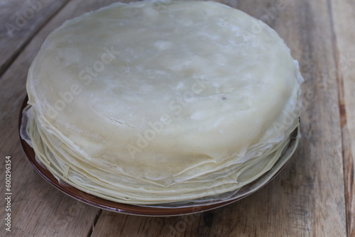 Pile of spring roll wrappers in a plate on the table