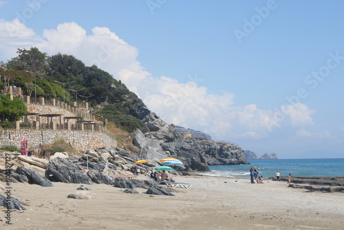 Fototapeta Naklejka Na Ścianę i Meble -  Rocky sea beach on a sunny day in Alanya, Turkiye, May 2023.