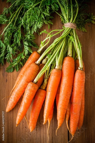 fresh carrots bunch on rustic wooden background
