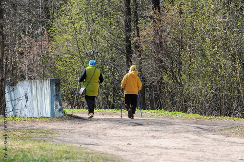Women with Scandinavian walking sticks are engaged in walking on an April morning. Moscow region Russia