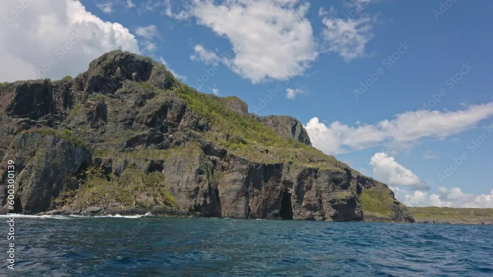 Rocky cliff and cave seen from boat, Playa Fronton beach in Samana Peninsula, Dominican Republic. Handheld shot Rocky cliff and cave seen from boat, Playa Fronton beach in Samana Peninsula, Dominican Republic. Handheld shot