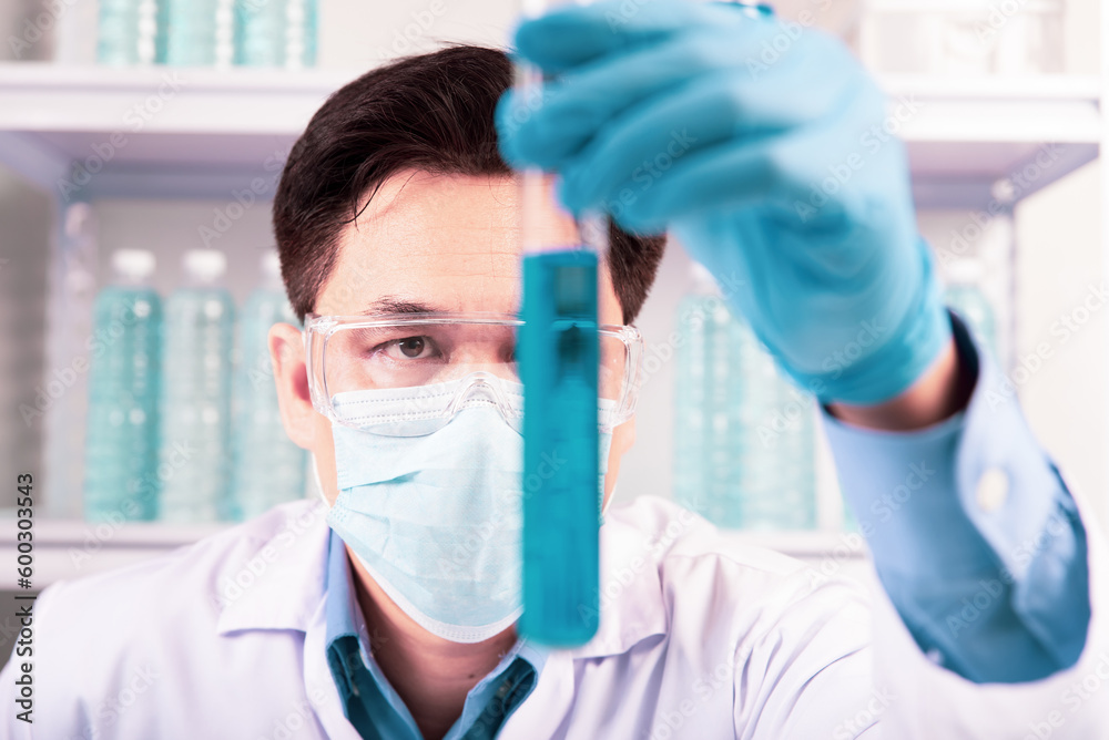 chemist,scientist hand holding experimental test tube and look at the contents of it in lab , science research and development concept chemist,scientist hand holding experimental test tube and look at the contents of it in lab , science research and development concept