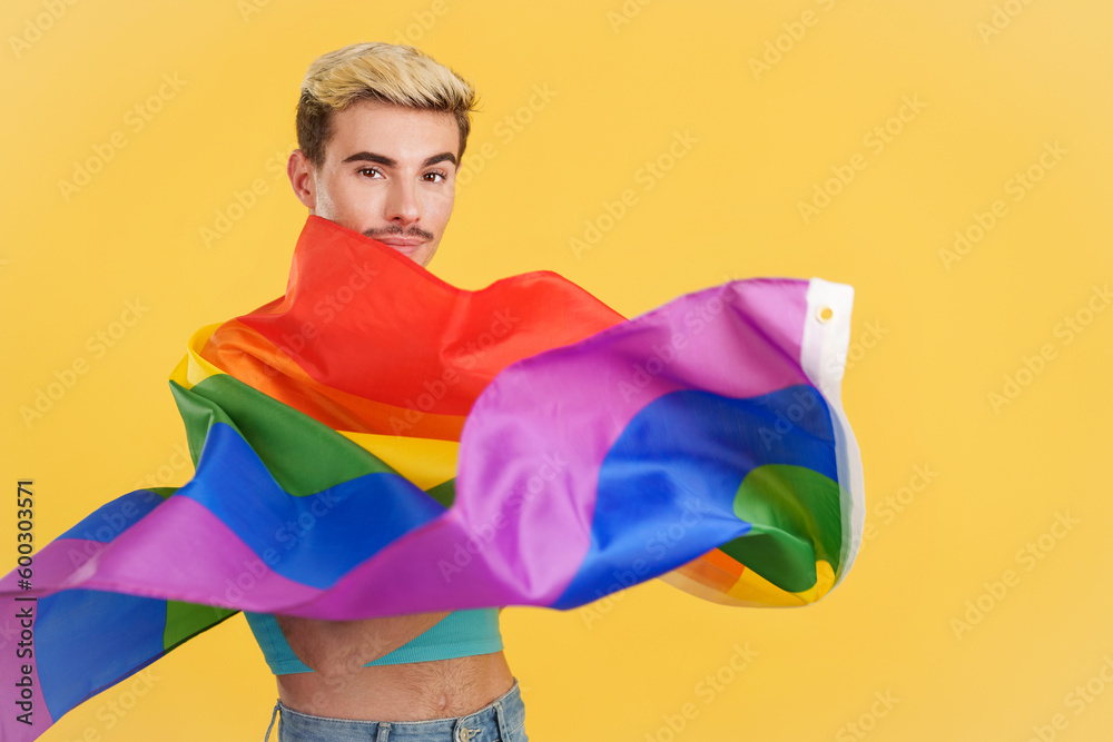 Happy gay man waving a lgbt rainbow flag Happy gay man waving a lgbt rainbow flag
