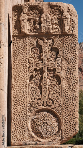 Medieval khachkar to the right of Surb Astvatsatsin (Burtelashen) Church on sunny day. Naravank Monastery, Vayots Dzor Province, Armenia. photo