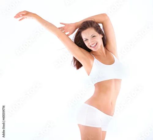 Obraz Isolated woman, stretching body and studio portrait for smile, wellness and lingerie by white background. Excited girl, model and young for underwear, happiness or health with fitness, beauty or sexy