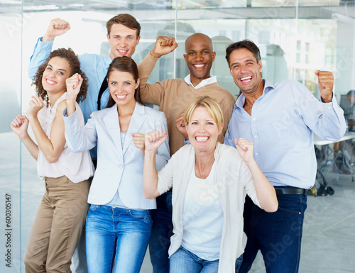 Business people, portrait and fist in celebration for success, winning or teamwork at office. Group of employees with smile in happiness for team win, victory or achievement for goals at workplace