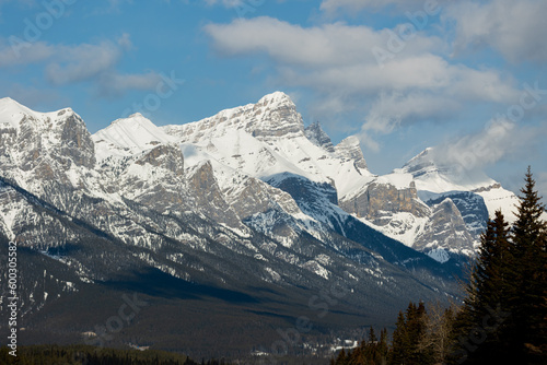 Magnificent scenery along the highway to Banff National Park in spring time with blue sky behind cascading snow capped mountains above.  © Scalia Media