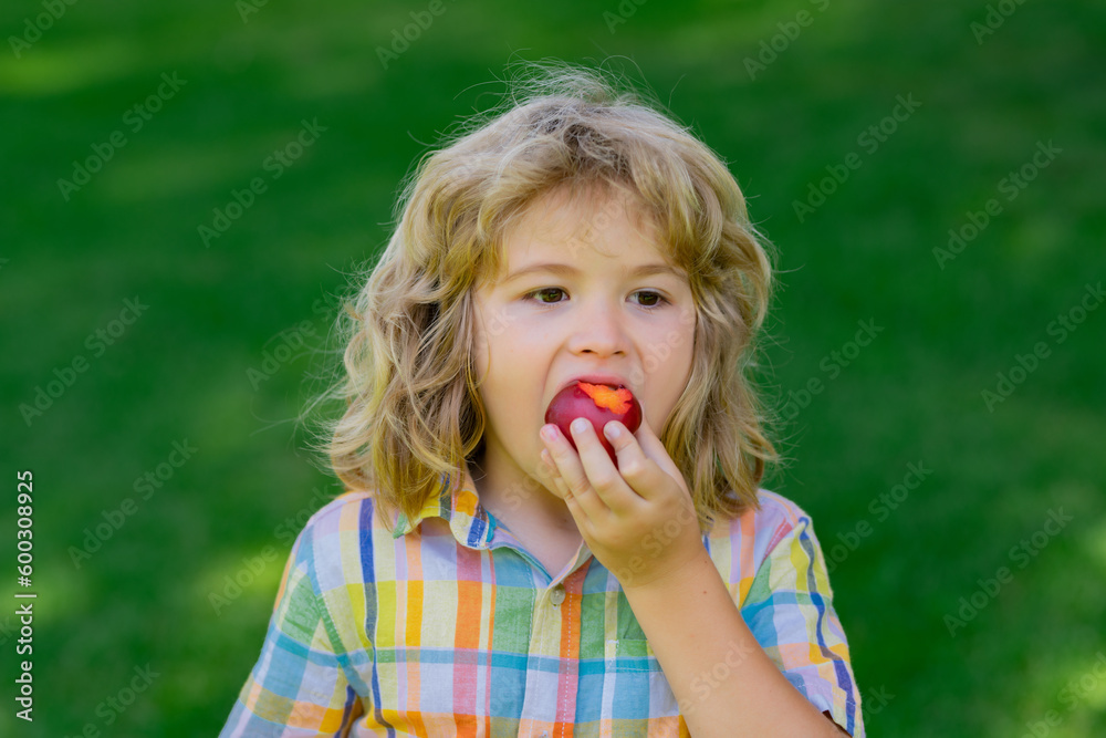 Summer cute kid face. Kid boy eats plum. Excited face. Strawberry for kids. Amazed expression, cheerful and glad.