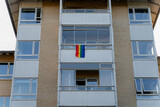 Rainbow flag. A rainbow flag hangs on the balcony of a residential building.