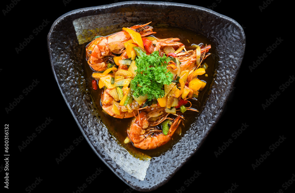 Salt fried shrimp with sauce and vegetables isolated on black backround Salt fried shrimp with sauce and vegetables isolated on black backround