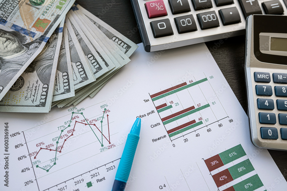 Accounting charts and graphs with us dollar bills pen calculator Accounting charts and graphs with us dollar bills pen calculator