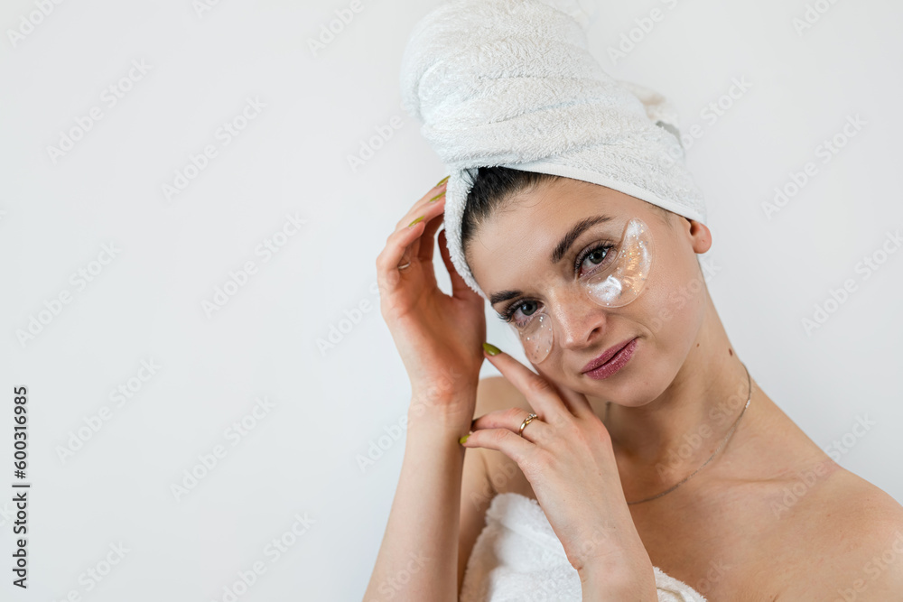 Charming female lady using collagen patch under eye for clean smoothing skin isolated on white Charming female lady using collagen patch under eye for clean smoothing skin isolated on white