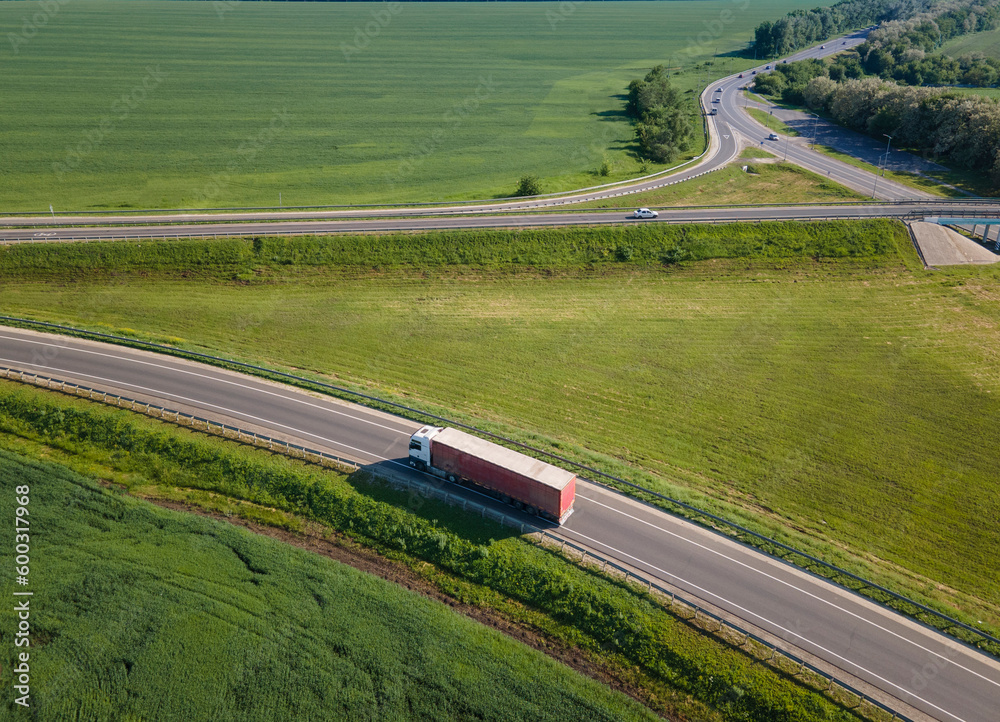 Truck with Cargo Semi Trailer Moving on Summer Road. Aerial Top View. White vehicle