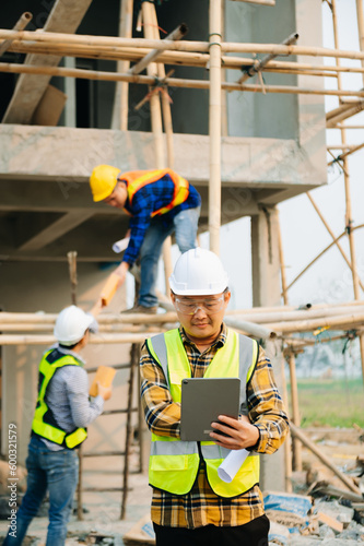 Architect caucasian man working with colleagues mixed race in the construction site. Architecture engineering on big project. Building in construction interior. © Nuttapong punna
