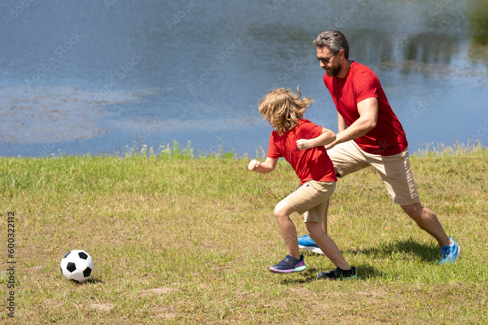 Father and son playing football together. Dad with kid spend hours practicing passing and