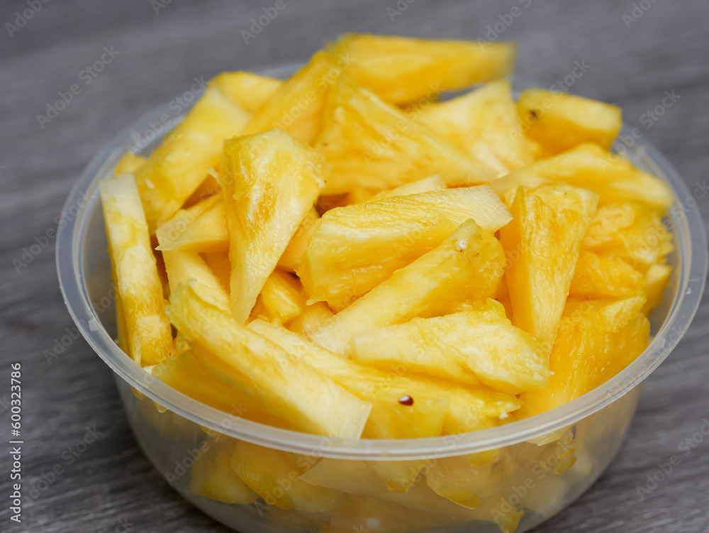sliced fresh pineapple in a transparent container. healthy food and diet concept sliced fresh pineapple in a transparent container. healthy food and diet concept