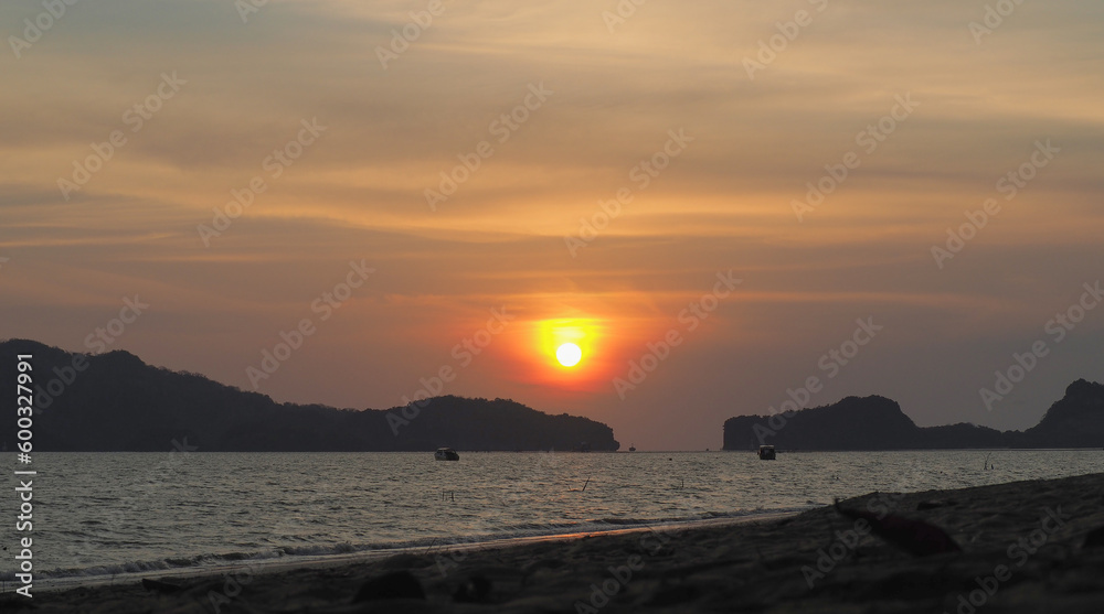 Sunrise, sunset, reflection of the waves in the sea running on the sandy beach. The beautiful fresh sea scenery is suitable for vacation travel.