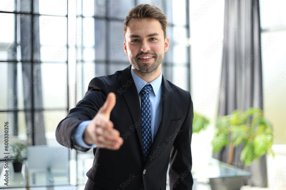 Businessman with an open hand ready to seal a deal. Businessman with an open hand ready to seal a deal.