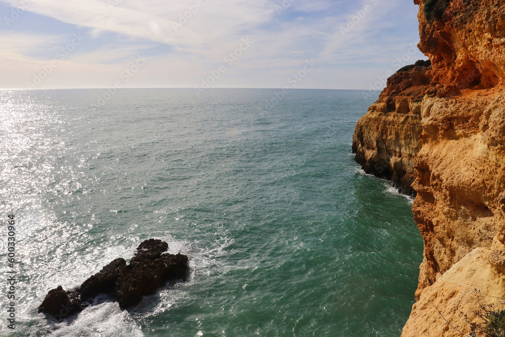 Limestone cliffs next to the Atlantic Ocean on a winter day in Algarve, Portugal along the Seven Hanging Valleys Trail.