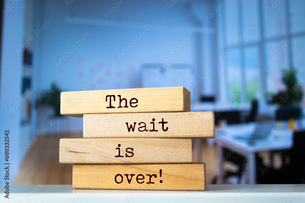 Wooden blocks with words ' The wait is over '.