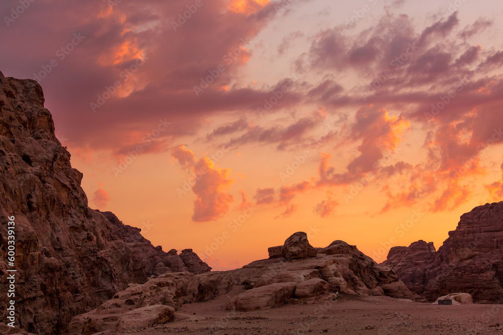 Sunset colorful orange sky landscape with sandstone rocks in Little Petra archaeological site, Jordan
