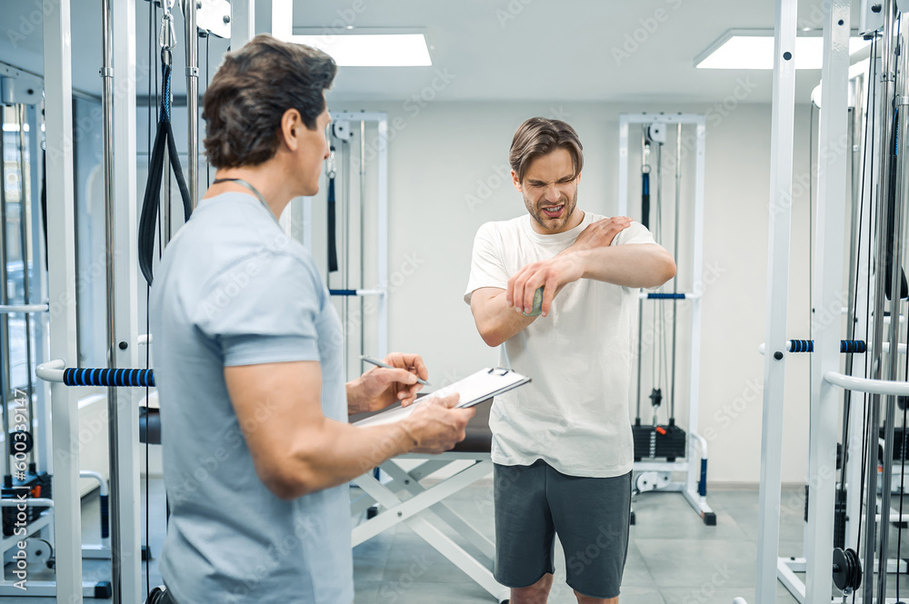 Male patient have a physical therapy session in rehabilitation center Male patient have a physical therapy session in rehabilitation center
