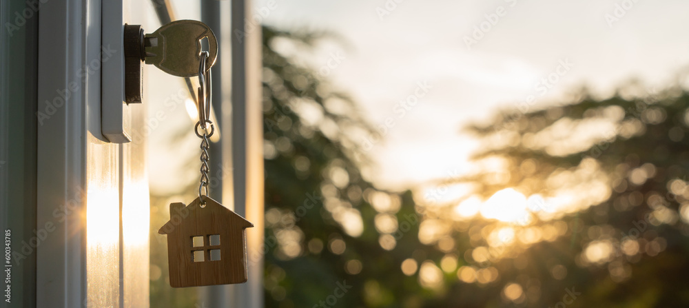 Obraz Landlord key for unlocking house is plugged into the door. Second hand house for rent and sale. keychain is blowing in the wind. mortgage for new home, buy, sell, renovate, investment, owner, estate fototapeta, plakat