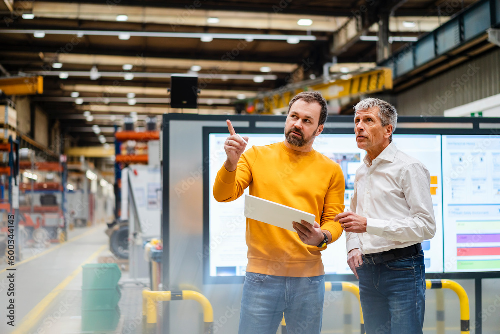 custom made wallpaper toronto digitalBusinessman explaining and having discussion with colleague in factory