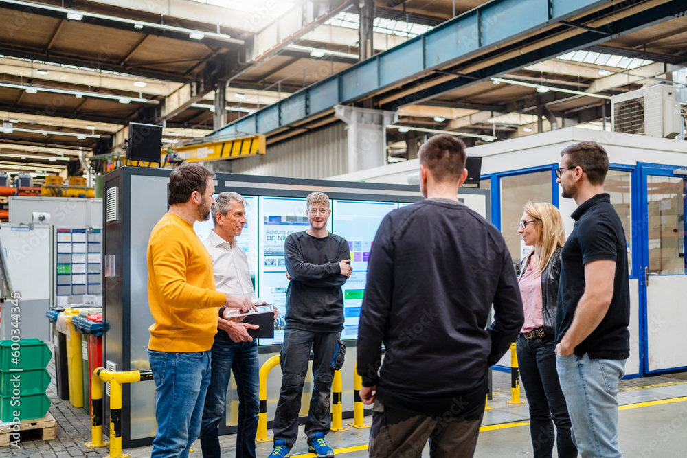 © Westend61 - Manager and businessman planning with employees at factory © Westend61 - Manager and businessman planning with employees at factory