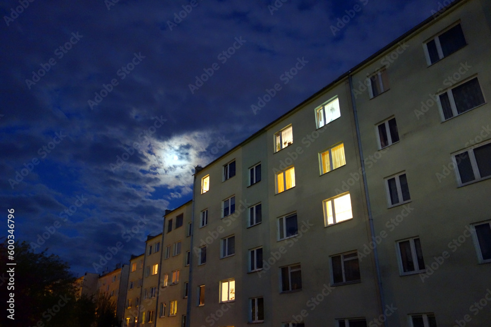 An old block of flats just after sunset with a beautiful blue cloudy sky