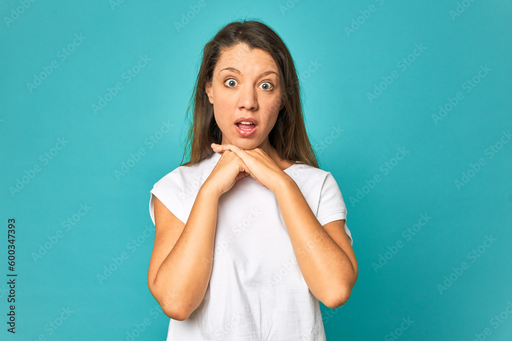 A young caucasian woman isolated praying for luck, amazed and opening mouth looking to front. A young caucasian woman isolated praying for luck, amazed and opening mouth looking to front.