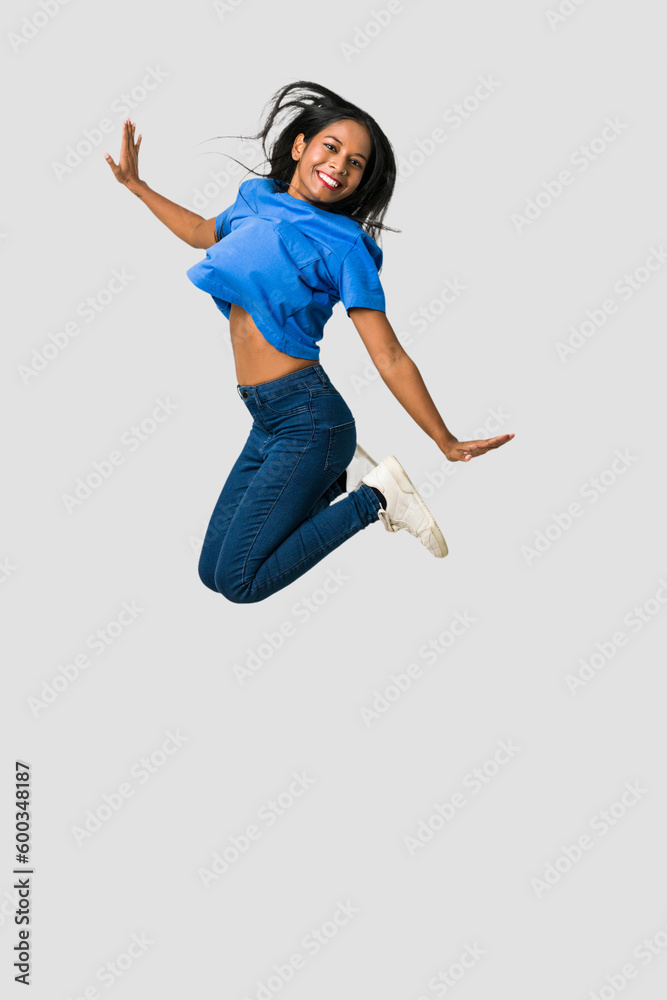 Young Indian woman happy jumping isolated on white background