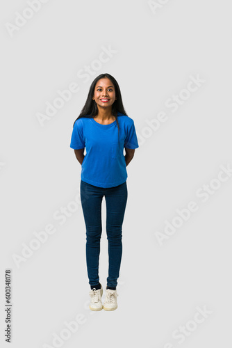Young Indian woman standing isolated on white background