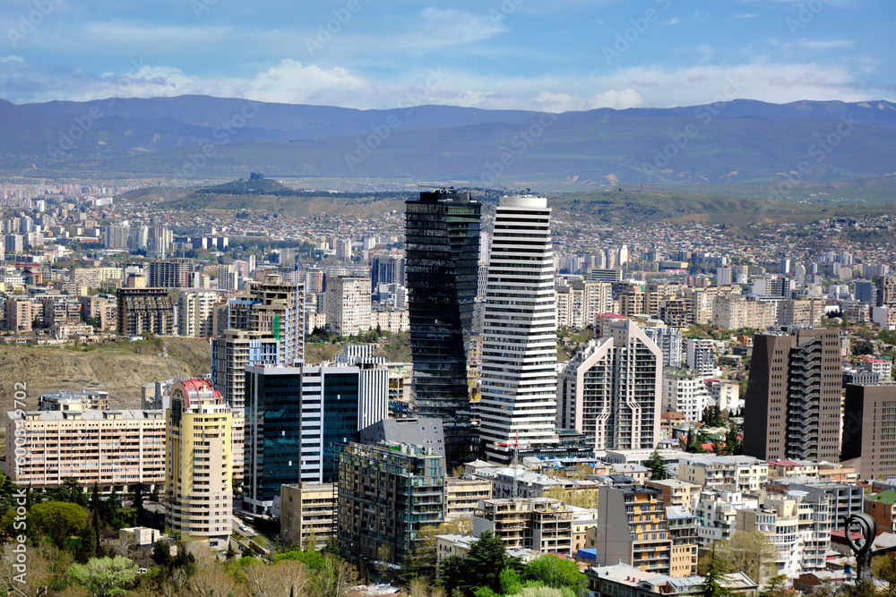 Fototapeta premium Aerial view of a large modern city with tall buildings.